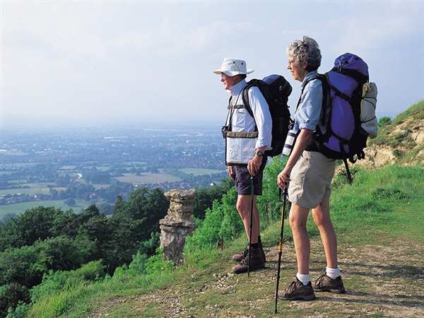 Walkers overlooking the Severn Vale and Devil's Chimney on Leckhampton Hill